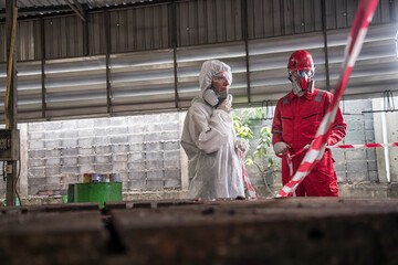 workers at work in a factory. person in mask. Hazardous control related to factory chemicals. Employees are disposing of harmful substances. in a chemical protective suit in a factory