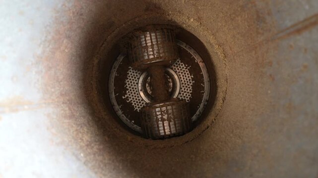 Granulator machine interior view showing rotating components and material flow, highlighting the continuous action of grinding and processing