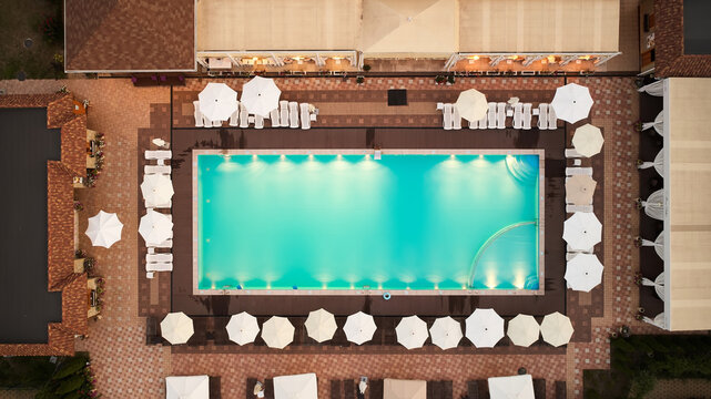 Aerial top-down view of a luxury resort swimming pool filled with turquoise water