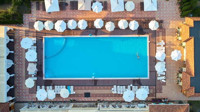 Aerial top-down view of a luxury resort swimming pool filled with turquoise water