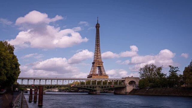 Metro trains passing the Bir Hakeim bridge in Paris France, crossing the river Seine and the Eiffel Tower behind. Time lapse clip