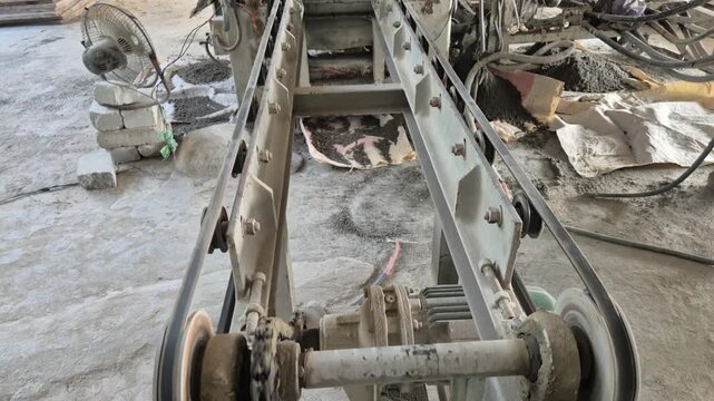 Professional RAW eye level wide shot of an automated conveyor belt for brick production in a factory in Bangladesh, 4K UHD 30fps.