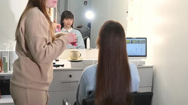 A young woman looks at the results of a trichoscopy performed by a trichologist. Hair condition assessment, hair loss treatment, and dandruff treatment.