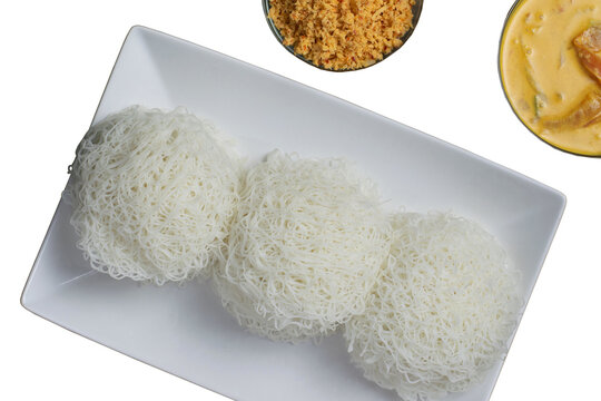 Traditional Sri Lankan String Hoppers (Idiyappam) with Pol Sambol and Curry on White Plate