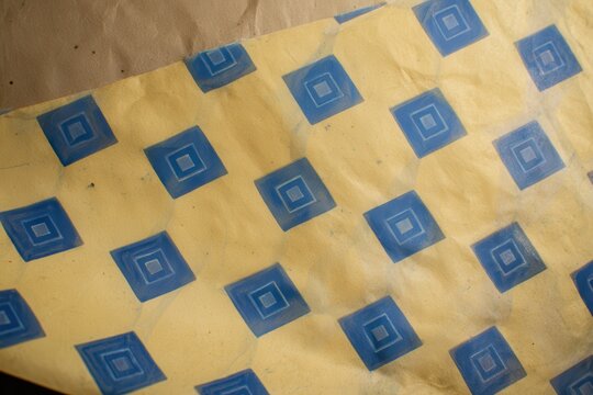 Vintage envelope lining, geometric blue pattern on yellowed paper, security tint
