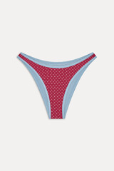 Red and light blue polka dot thong underwear laid flat on a white background