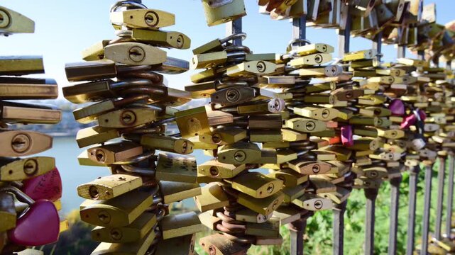 Countless padlocks attached to a bridge railing representing love, romance, and lasting devotion, Novi Sad, Serbia