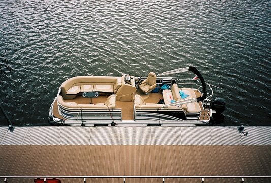 Luxury pontoon boat moored at a modern pier in Prague, analog photography
