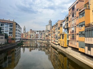 Fototapeta premium Scenic urban views of Catalonia featuring Girona’s iconic Iron Bridge, charming historic streets of Manresa, and picturesque corners of Balaguer, showcasing authentic architecture and vibrant local at