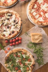 Savor the warmth of homemade pizza and pasta crafted with love on a wooden table. Fresh ingredients...