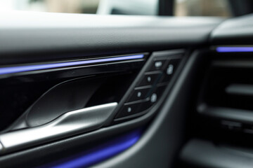 Close up of a modern car interior.  Door handle and control panel with soft lighting.  Stylish and clean automotive desi © vegefox.com