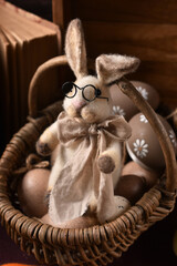 A portrait of handicraft bunny in a wicker basket in vintage style