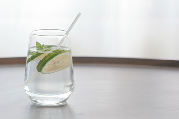 Fresh Lemon Mint Detox Water Glass on Clean White Surface - Healthy Summer Drink with Minimalist Aesthetic