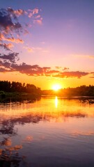 Obraz premium Serene lake sunset with calm waters and vibrant sky.