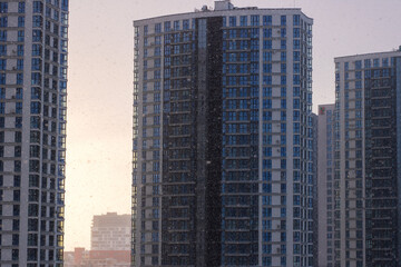 Obraz premium Dusk casts warm reflections on towering residential blocks in lively metropolitan area