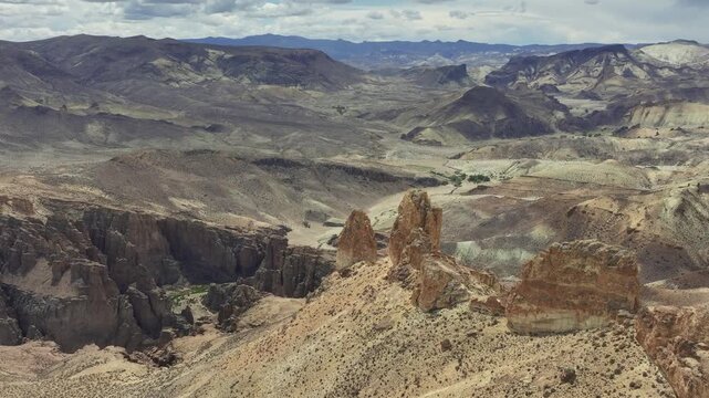 Aerial view of epic volcanic rock formations and deep canyons in the Piedra Parada Natural Protected Area in Chubut, Argentina