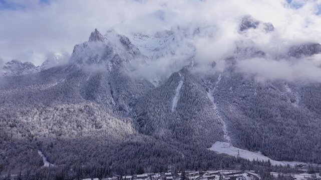 Westliche Karwendelspitze drone view. High angle shot of Mittenwald, Bayern. Luftaufnahme vom Isartal im Schnee. Beautiful alpine landscape in Werdenfelser Land, last stop before Tyrol, Austria.