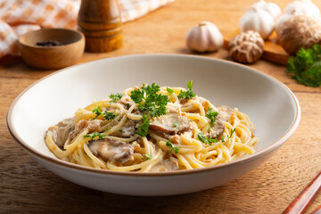 Pasta with creamy mushroom sauce,Spaghetti with shiitake mushroom and parsley in white plate.Italian traditional dish.