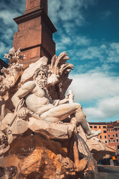 Fontana dei Quattro Fiumi, a masterpiece of Baroque art by Gian Lorenzo Bernini, with its majestic statues and ancient Egyptian obelisk against a blue sky