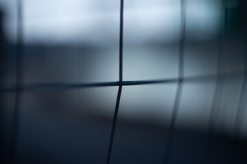 Abstract dark geometric background with blurred lines and soft light shadows.