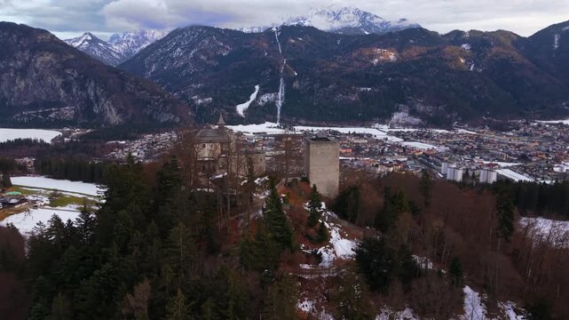 Cinematic drone video of Thierberg Castle ruins above Kufstein, Austria. Popular alpine viewpoint Inn River, Inntal, snowy hills and Kaiser Mountains. Luftaufnahme Thierbergkapelle und Burg Thierberg