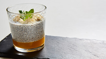 Artisanal breakfast parfait featuring layered chia seed pudding, mango puree © sarymsakov.com