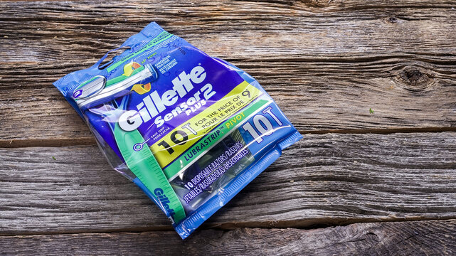 NORWALK, CT, USA - FEBRUARY 20, 2026:A package of Gillette Sensor Plus 2 razors sits on a wooden table. An individual razor lies beside the package. The pack contains ten razors. The setting is simple