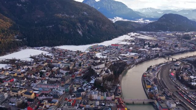 High angle drone view of the historic center of Kufstein. Fortress hill and snowy Brandenberg Alps. Luftaufnahme der Festung Kufstein. Iconic landmark in Tirol by the Inn river in winter.
