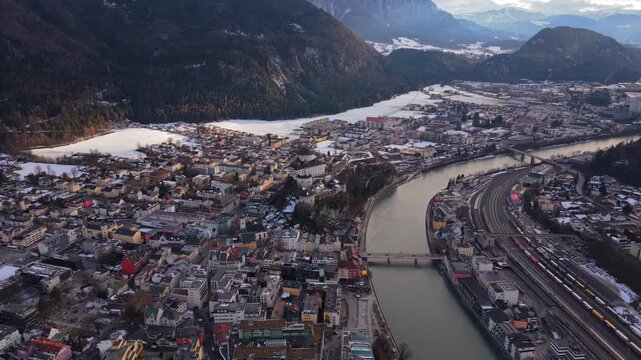 Cinematic aerial view of Festung Kufstein in winter. Iconic landmark of Tyrol, Oesterreich. Luftaufnahme der Festung Geroldseck im Schnee. High angle shot of the fortress hill and Inn river.