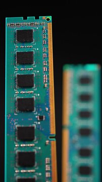 DDR RAM memory chips module macro view. Hand holding Random Access Memory RAM module disconnected from computer motherboard. Manufacturers redirect capacity production for AI data centers. Vertical.