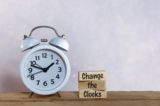 Change the Clocks Daylight saving time concept with sunflowers alarm clock copy space