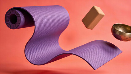 Obraz premium Floating purple yoga mat with yoga block and singing bowl. Spring equinox balance and renewal meditation setup. Wellness and mindfulness concept for inner peace