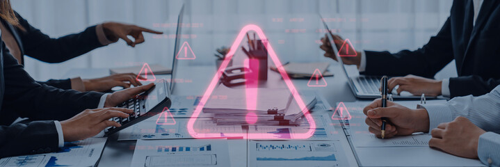 A business team engages in a discussion about financial risk management, using data and visual...