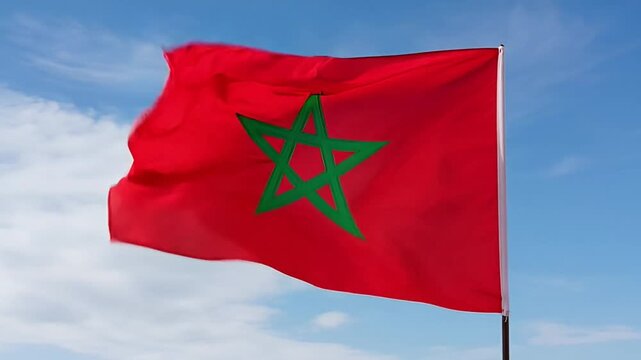 Moroccan flag waving dynamically in blue sky with white clouds, capturing national pride and vibrant movement