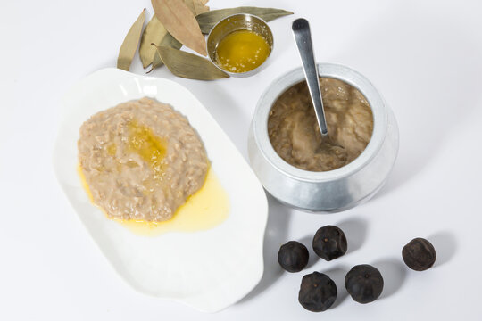 Delicious Bait Haly Hareesa or oat paste with olive oil and herbs on white plate top view