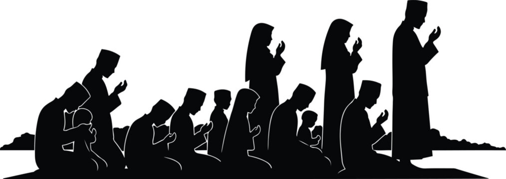 Muslim family praying together during sunset in silhouette