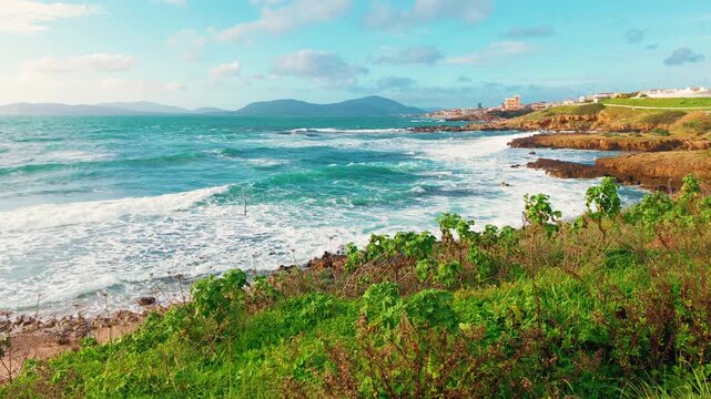 Slow motion view of a stormy sea in Alghero with powerful waves moving across the surface under dramatic coastal weather conditions in Sardinia Italy.