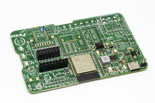 High angle perspective view of a green electronic development board PCB featuring an microcontroller module, female pin headers, Type-C USB port, and SMD components on a white background