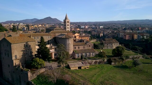 Viterbo Papal Palace and Santissima Trinita sanctuary aerial 4k view in Italy. Cinematic drone pan left from Palazzo dei Papi to medieval church on a rock and San Lorenzo cathedral. Heritage scenery