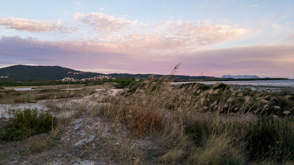 Panoramic sunset over Li Salineddi Pond with Tavolara Island on the horizon, Budoni, Sardinia.