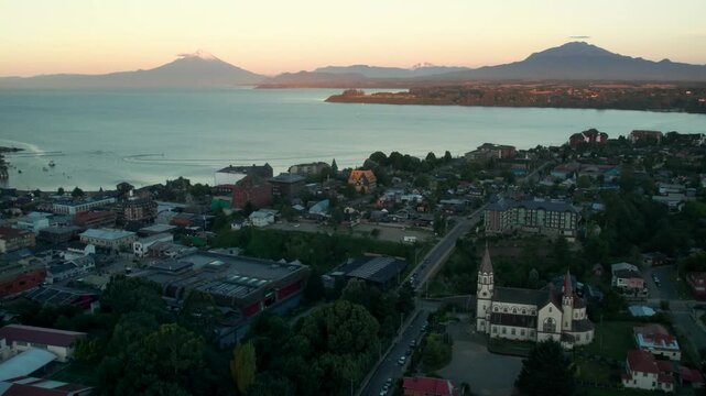 Puerto Varas, Chile - February 1, 2026: Aerial view of the city, Lake Llanquihue and Osorno Volcano at sunset, showing the lakeside town and surrounding landscape.