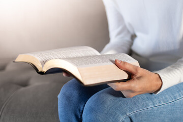 woman reading open bible at home, christian scripture study and spiritual reflection
