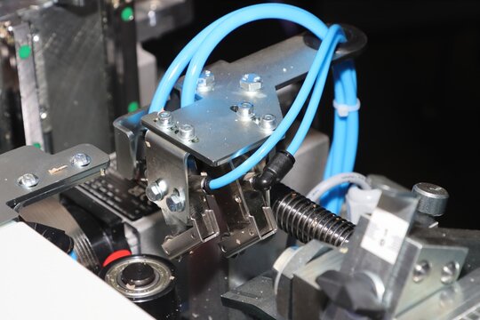 Close-up view of a pneumatic clamp used in automated machinery.
