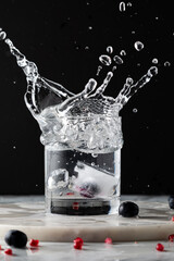 A large splash caused by ice being dropped into a glass of water. 