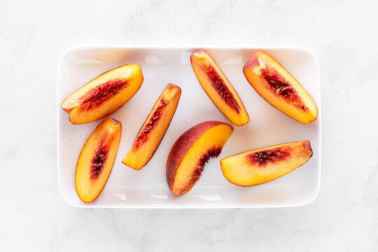 a platter of fresh segment slices from a juicy freestone peach.