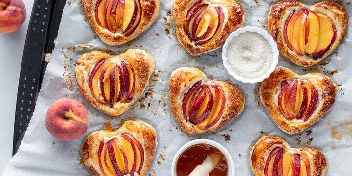 Freshly baked heart shaped peach filled pastries, topped with jelly and sugar.