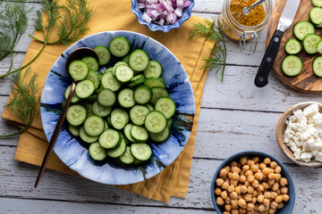 Fresh ingredients for making a healthy mini cucumber salad.