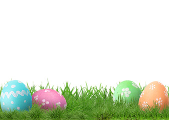 Fototapeta premium Easter eggs in green grass against white background