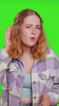 I cant hear you. What. Young woman trying hear you, looking confused and frowning, keeping arm near ear for louder voice, asking to repeat, to hear information, deafness. Girl on chroma key background
