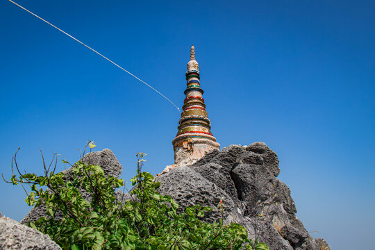 Pagodas on the top of mountains under blue sky, Chaloem Phrakiat Phrachomklao Rachanuson temple (Wat Phrabat Pu Pha Daeng) Unseen and Amazing temple in Thailand, Chae-Hom District, Lampang province.